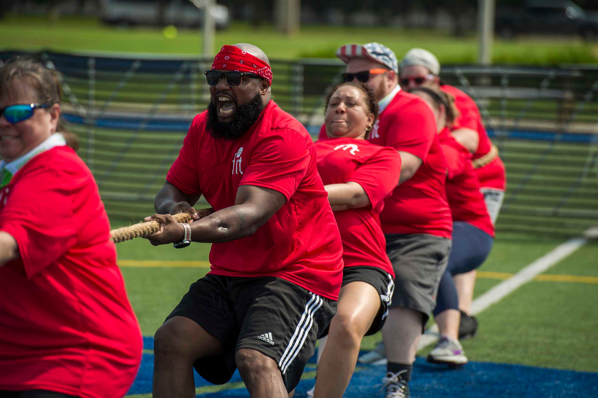 Team competing in a tug-of-war game at an outdoor field day