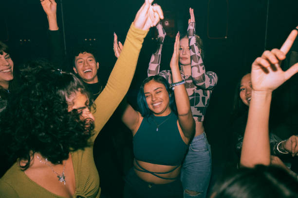 Group dancing together in a dark club