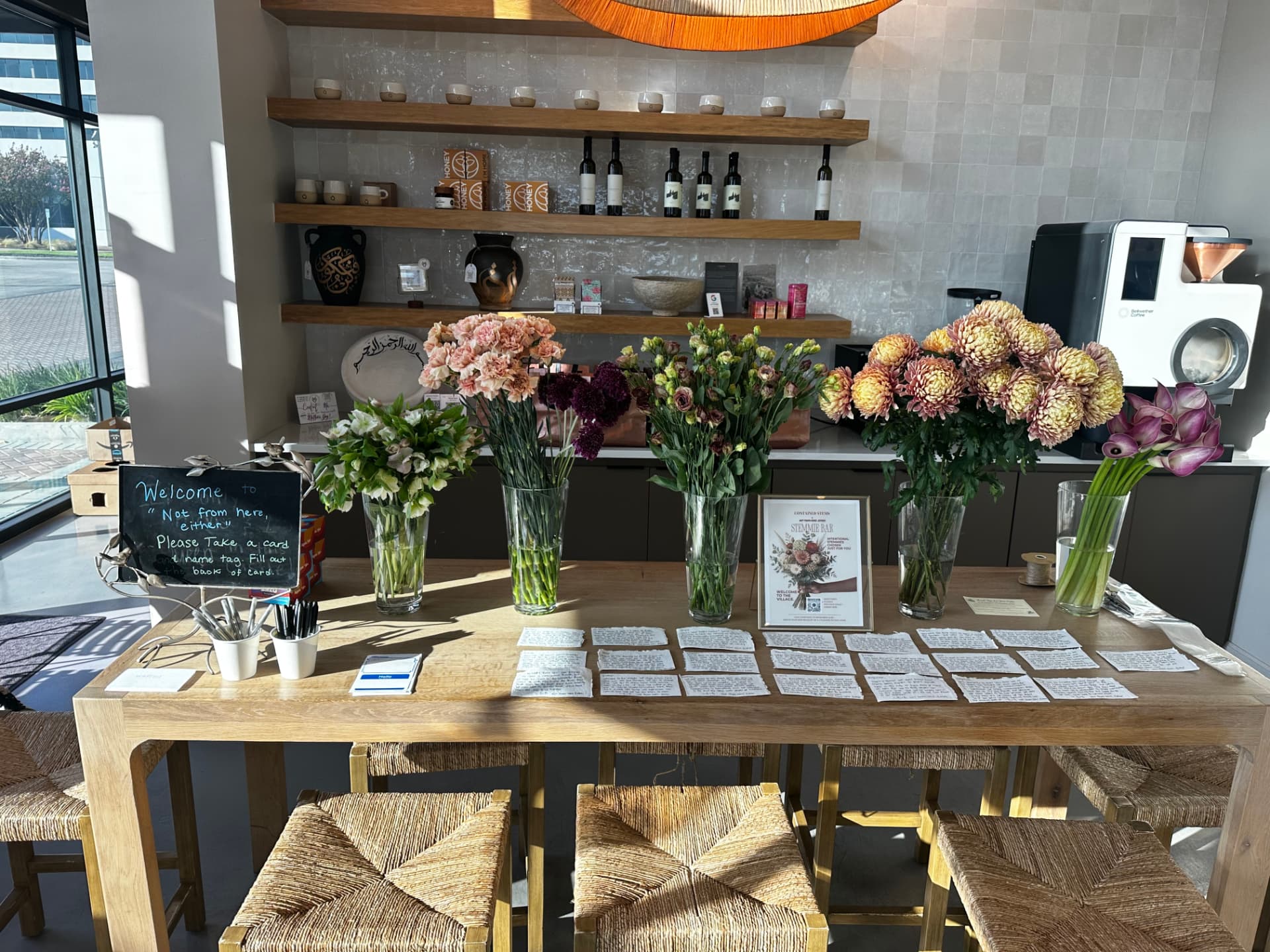 Welcome table with flowers, name tags and conversation cards