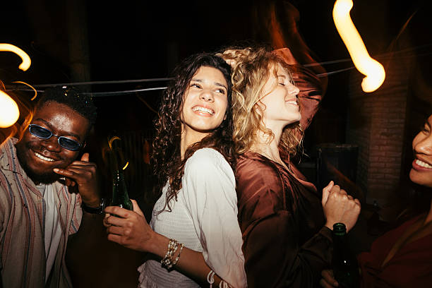 Friends dancing together at a dim NFHE venue